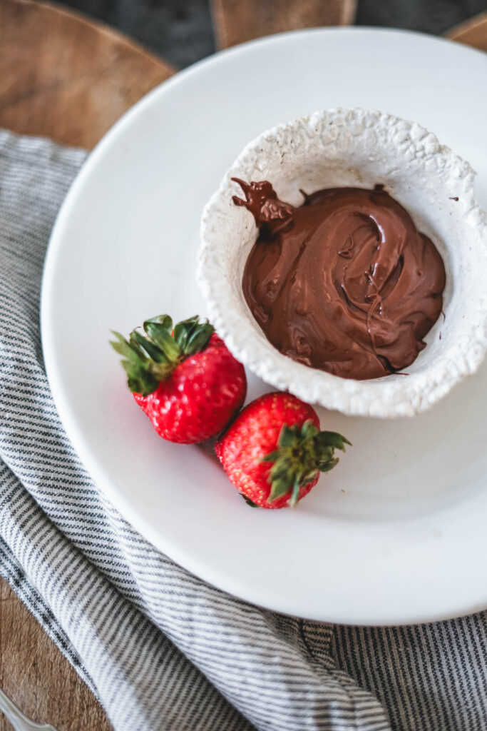 Melted chocolate to make chocolate covered strawberries.