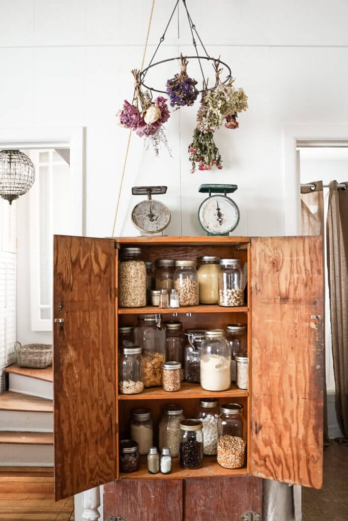Vintage kitchen cabinet full of jars in the kitchen.