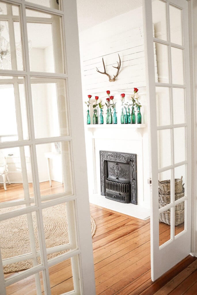 red and white roses on a fireplace mantle for valentines day