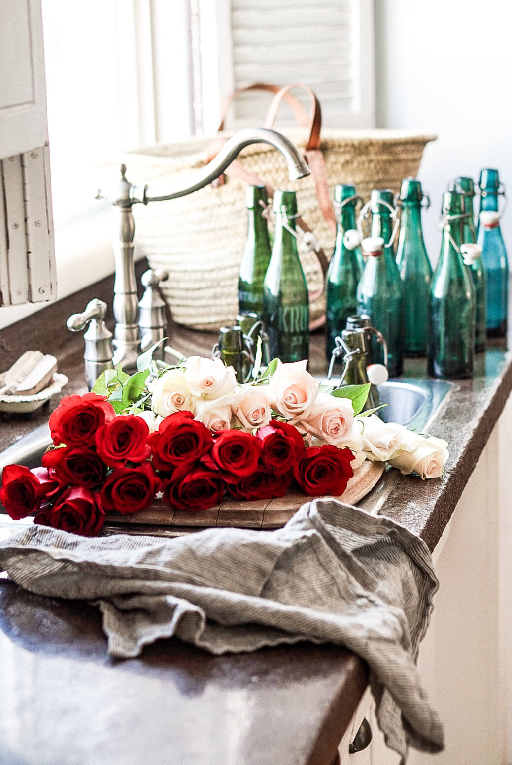 red roses beside a farmhouse sink