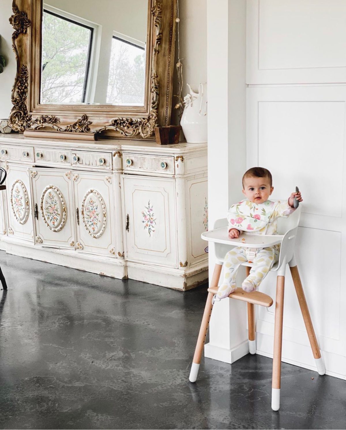 azure farm baby girl in high chair concrete floors white cabinets 