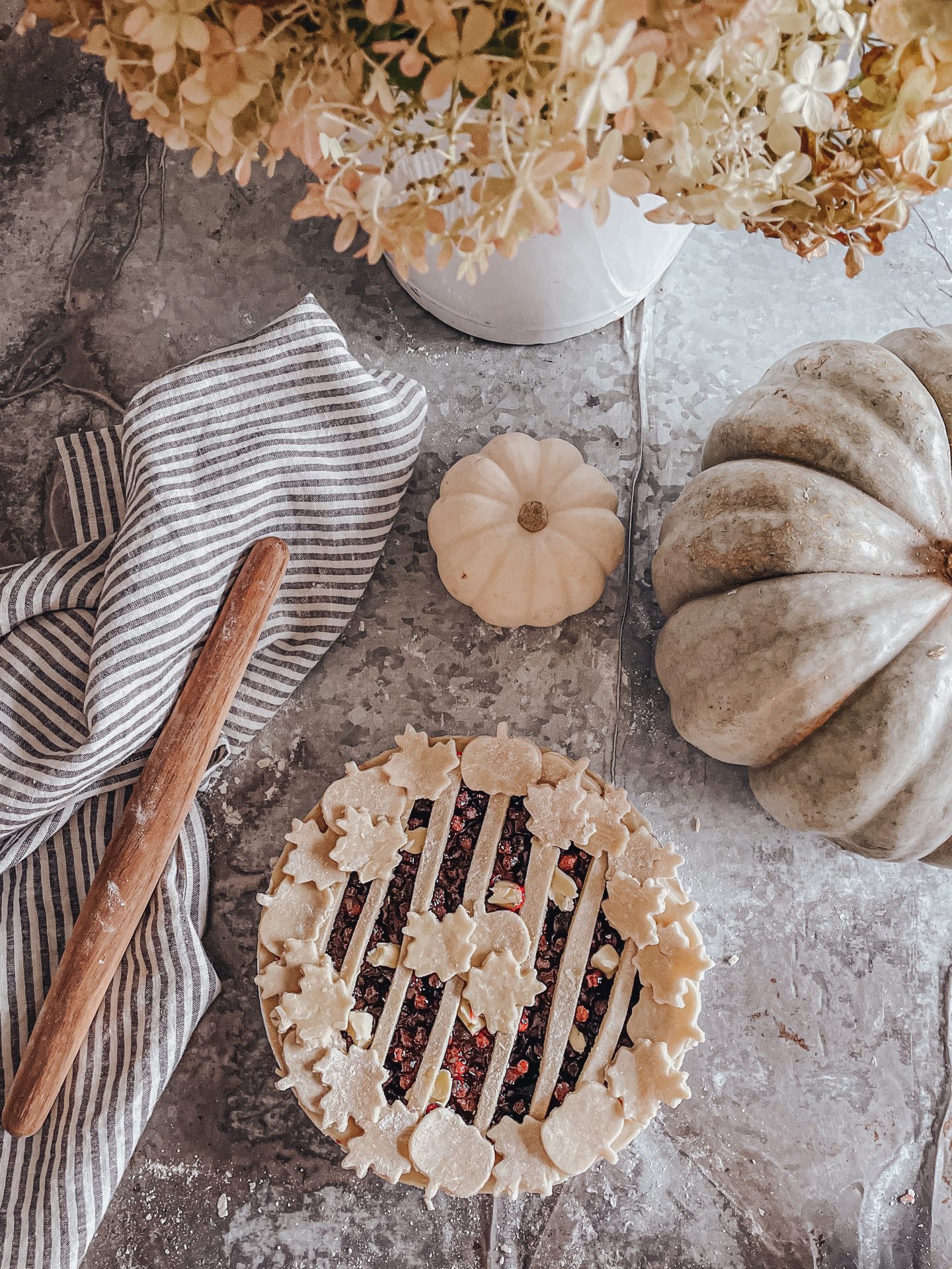 Saskatoon Berry pie in the fall with pumpkins and hydrangeas