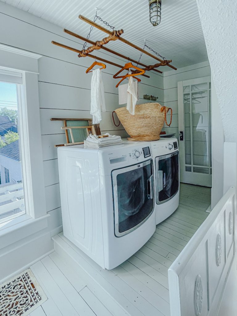 A beautiful shiplap laundry space with a washer and dryer.