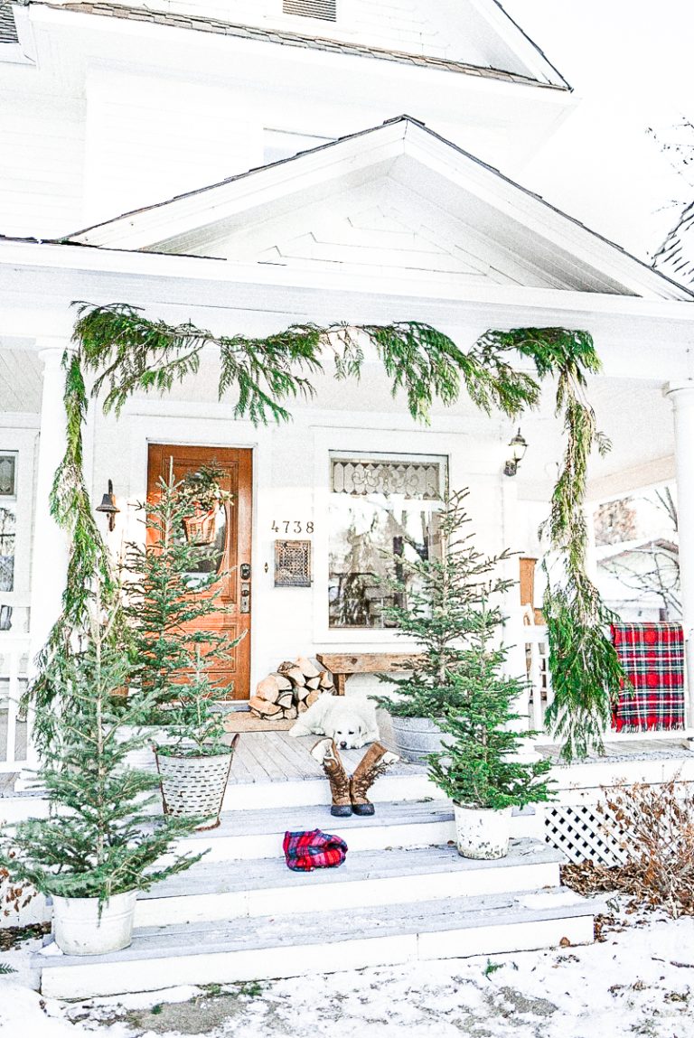 fresh greenery garland hung on a front porch