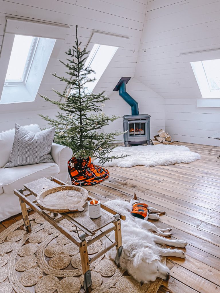 family room space with a wood burning stove and Scandinavian Christmas tree