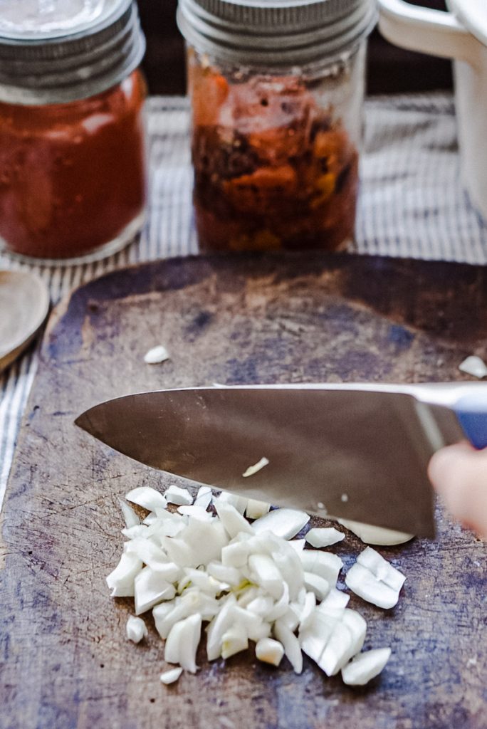 Dicing onions to make smoked tomato soup.