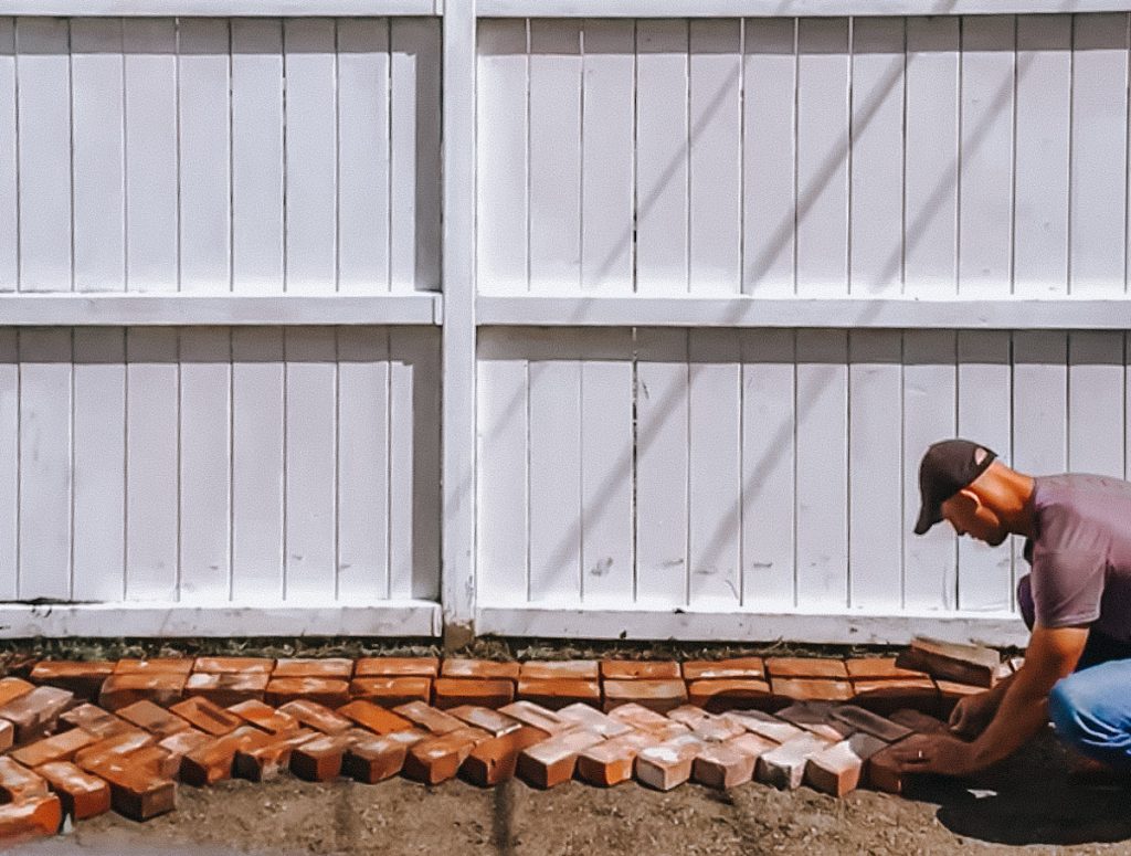 Making a DIY brick patio out of reclaimed bricks that were salvaged.