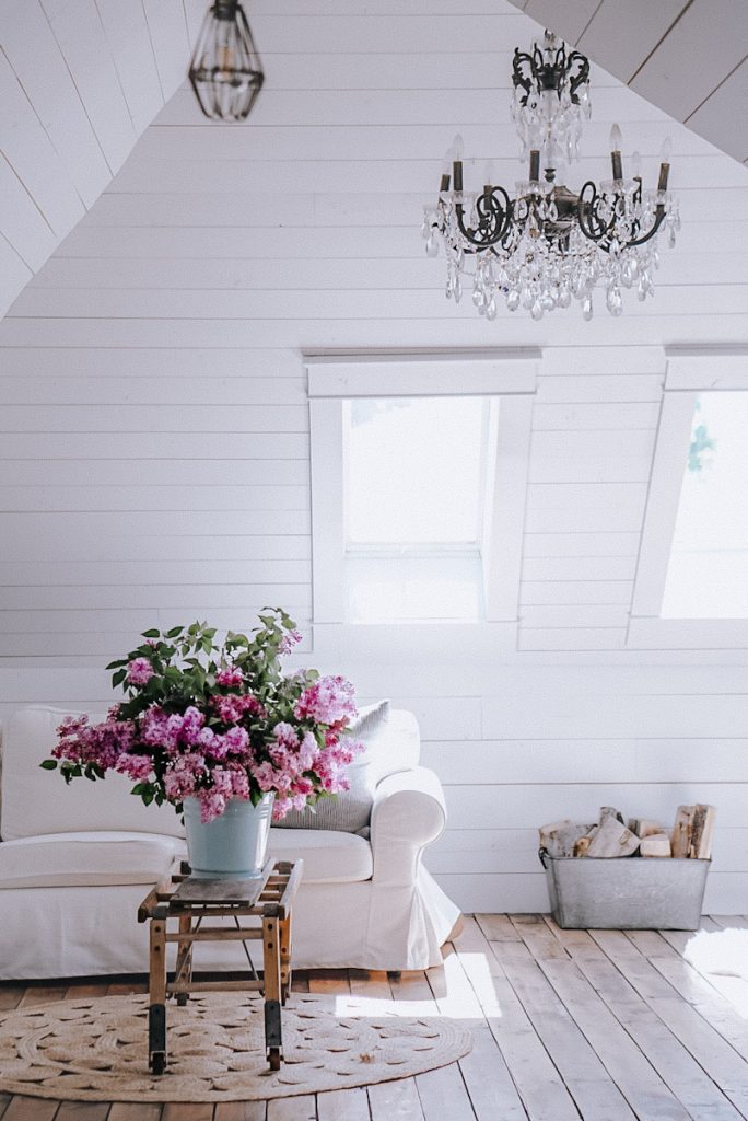 a lilac bouquet on a coffee table in an attic space