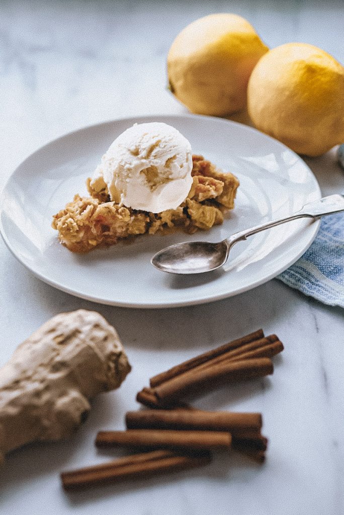 delicious serving of ginger and rhubarb crumble with ice cream on top