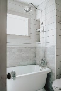 shiplap in a shower with marble tile and a freestanding tub