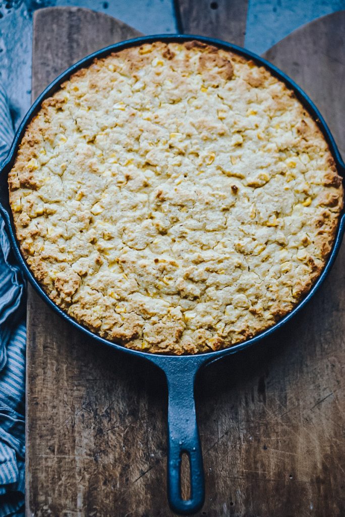 Cornbread in a skillet that has just come out of the oven.