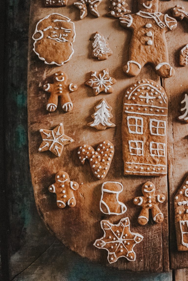 Decorated Gingerbread cookies with icing on a vintage cutting board.