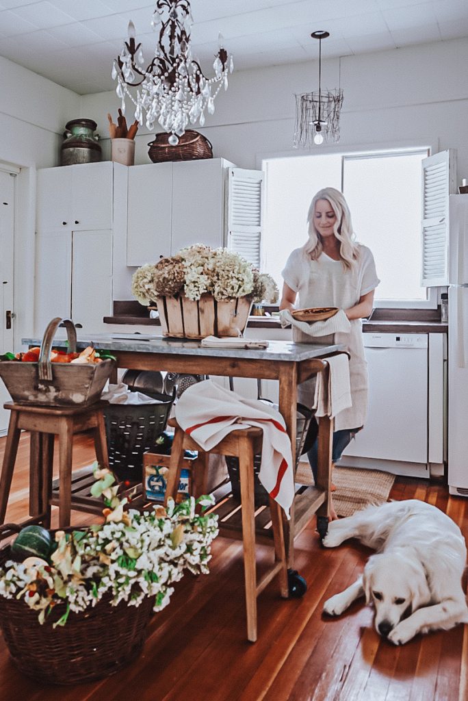 Deborah, B Vintage Style, in the cozy hygge styled kitchen with fresh baked goods and beautiful fall flowers in baskets.