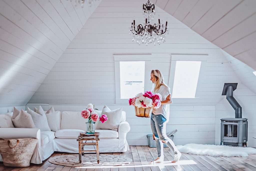 Deborah, B Vintage Style, decorating the living room space with fresh peony flowers as the sun shines in.