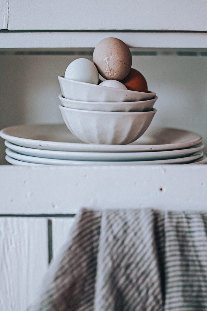 Beautiful stoneware bowls filled with farm eggs.