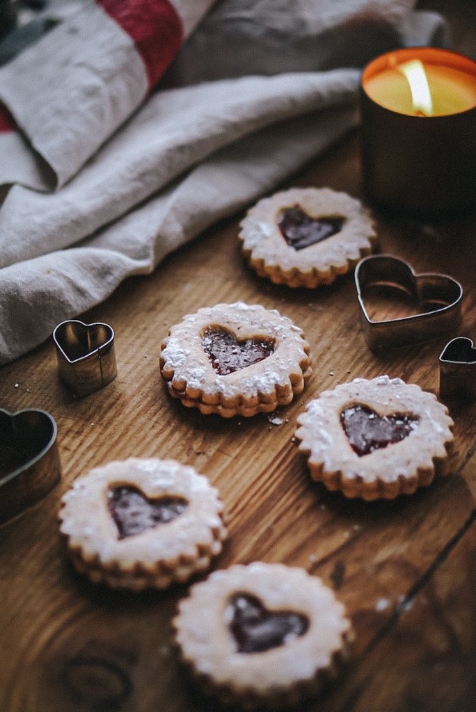 Valentine's Day Linzer Tart Cookies with heart cut outs on the top.