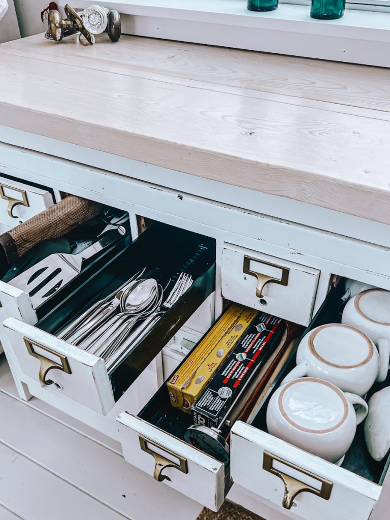 small drawers organized with similar types of kitchen utensils in a organized kitchen