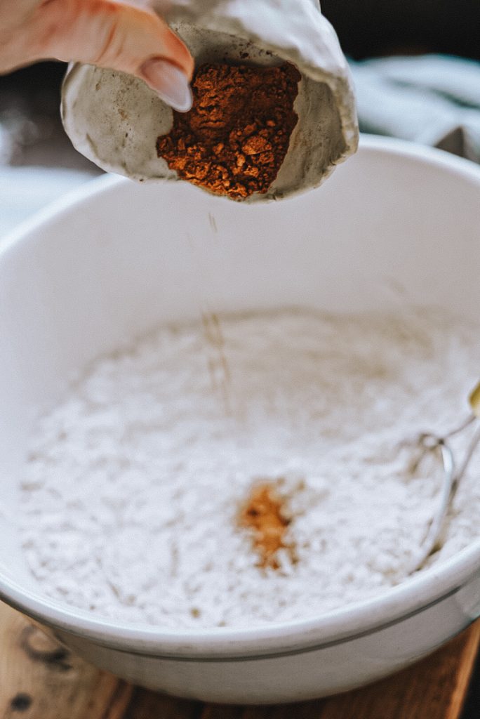 Cinnamon being added to make bread dough.