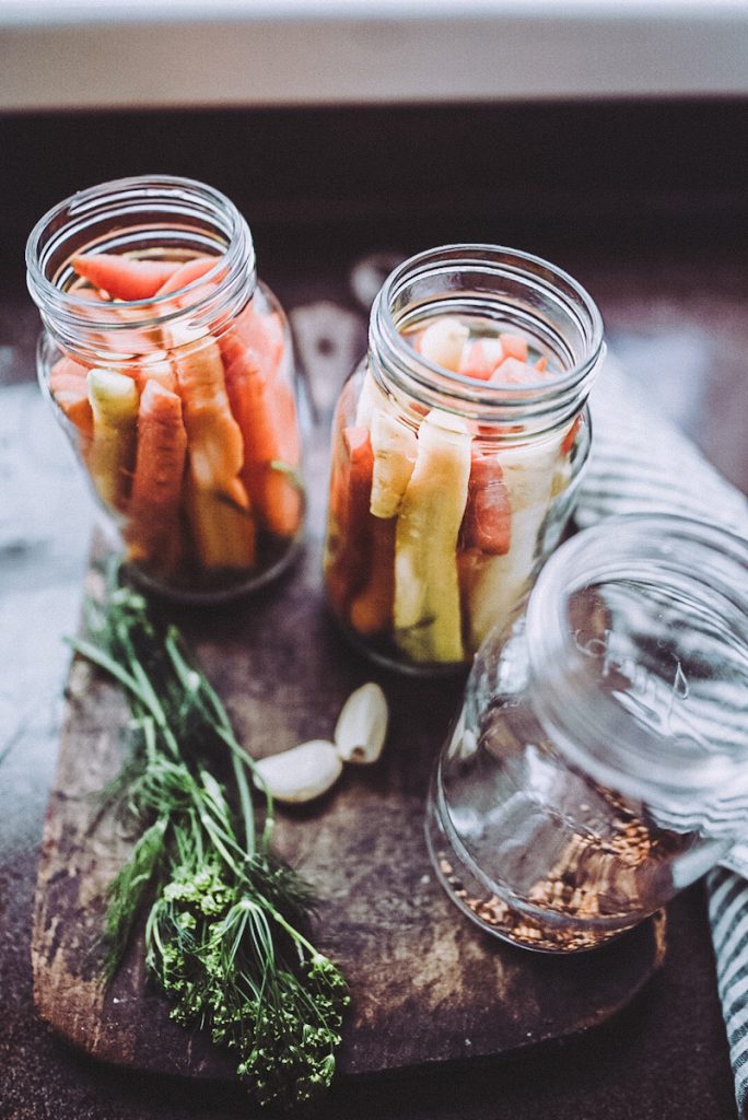 Carrot in jars on a table.