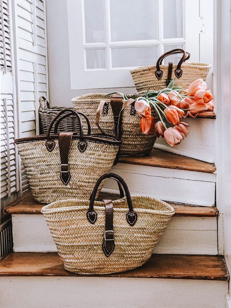 French market baskets stacked on a set of curved stairs.