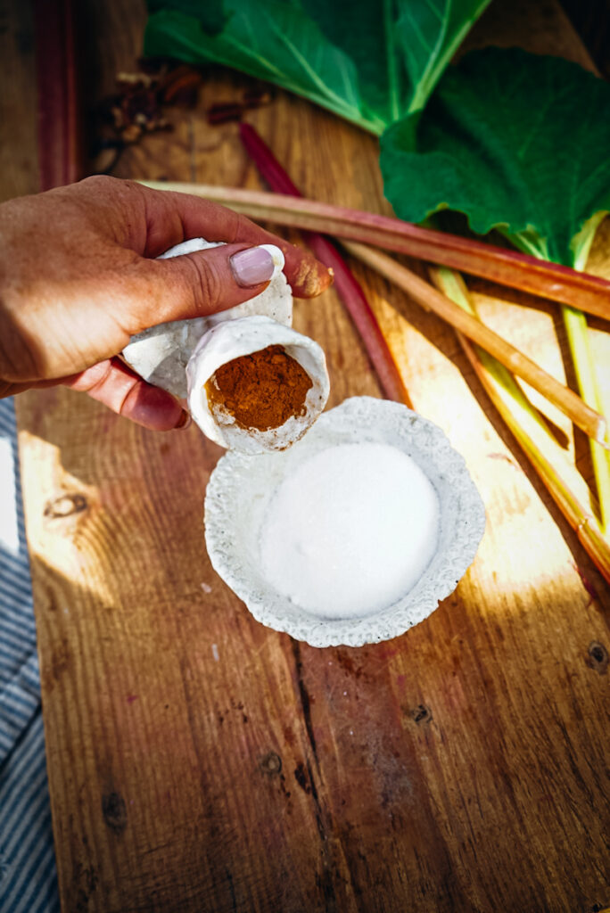 Cinnamon being adding to sugar.