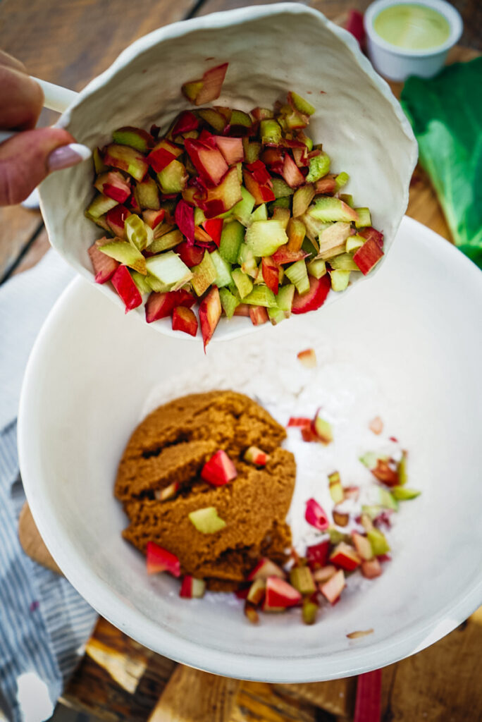 Adding rhubarb to the batter.