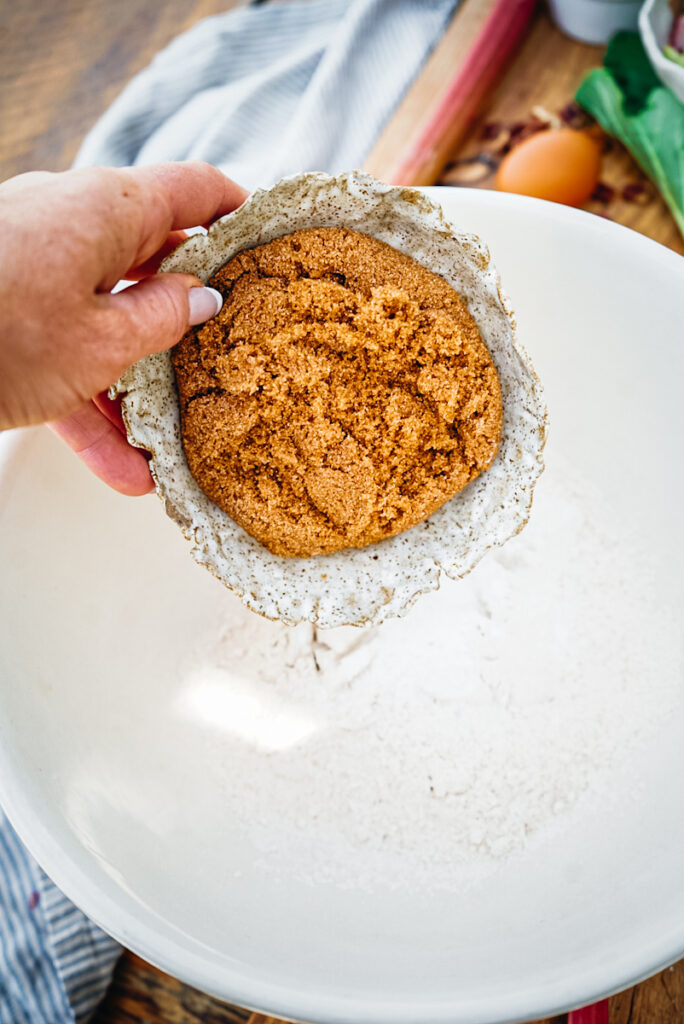 Adding brown sugar to a bowl.