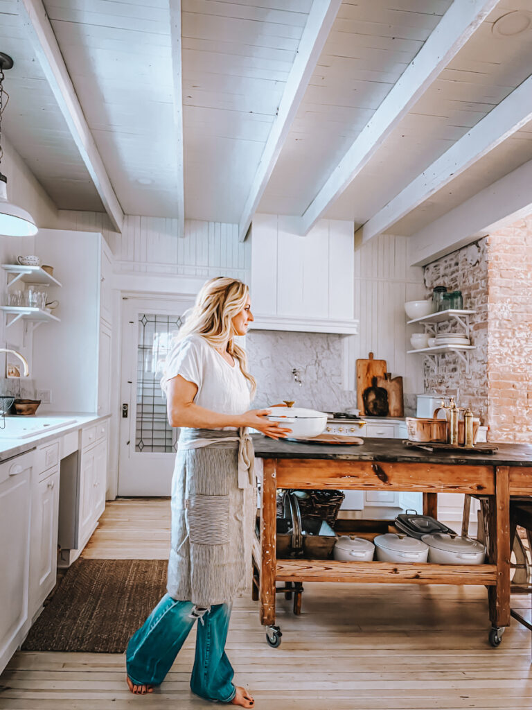 Deb, B Vintage Style walking through a beautiful white Scandinavian kitchen space.