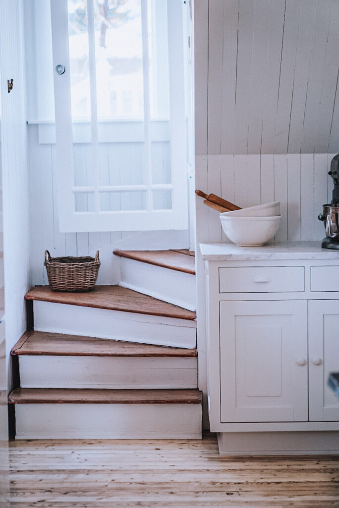 Old staircase with a basket on it beside a beautiful baking station.