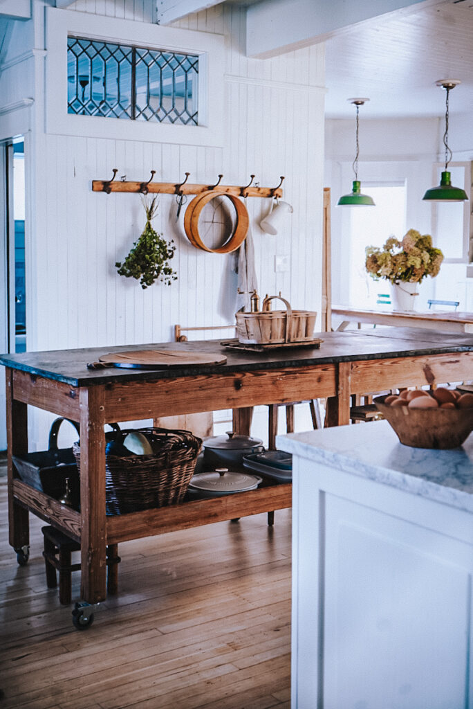 Antique floralist work bench being used as a kitchen island in a European style kitchen space.