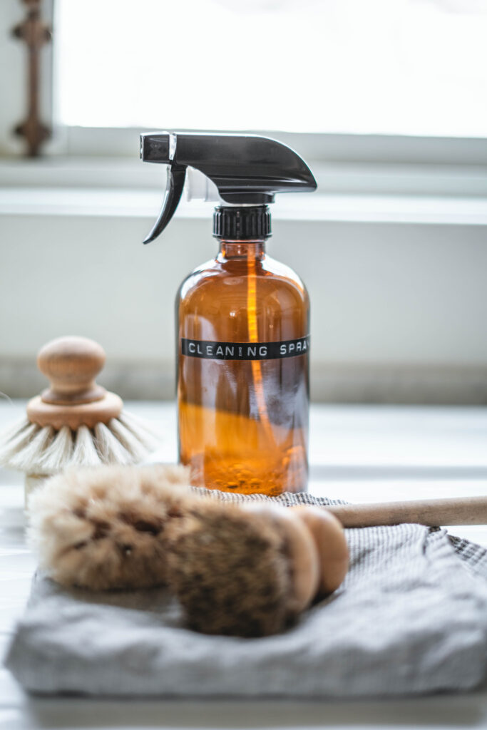 Homemade all purpose cleaner in a amber glass spray bottle with a label that says cleaning spray.