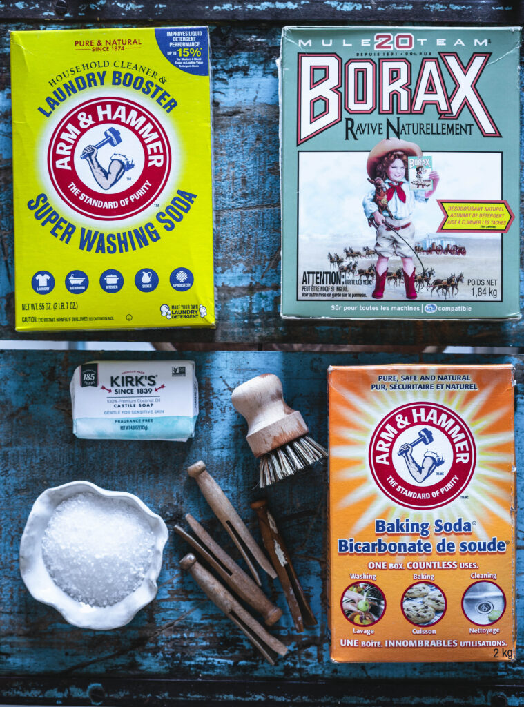 Supplies required to make DIY homemade laundry detergent including washing soda, Borax, baking soda, Epsom salt and Castile soap.