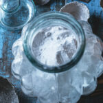 Homemade laundry detergent in an antique glass container.