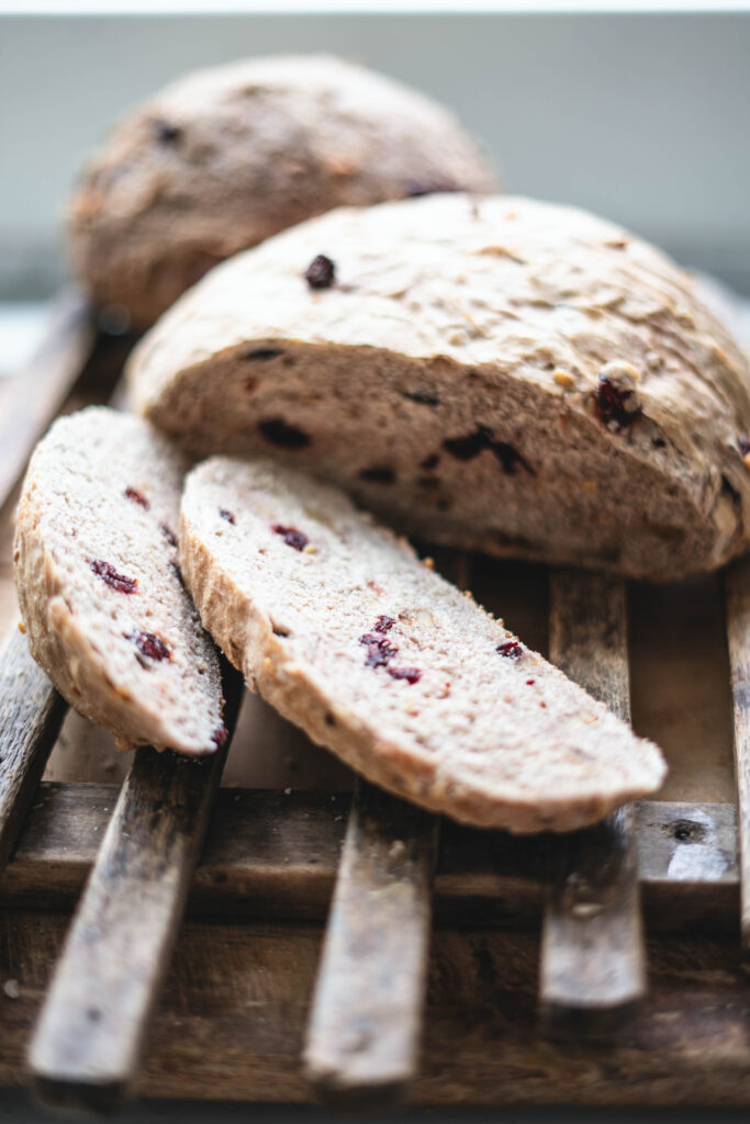 Fresh baked cranberry walnut bread that has been sliced to eat.