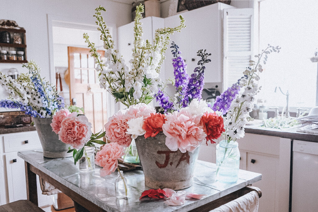 Buckets full of spring flowers all arranged on the kitchen island.