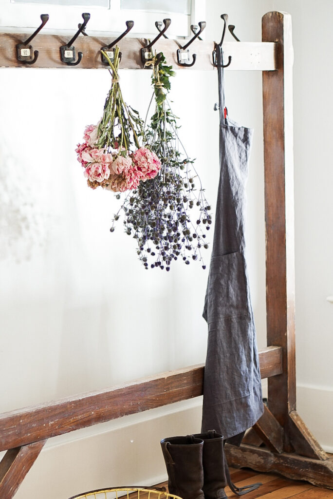 Flowers and peonies that have been hung on hooks to dry.