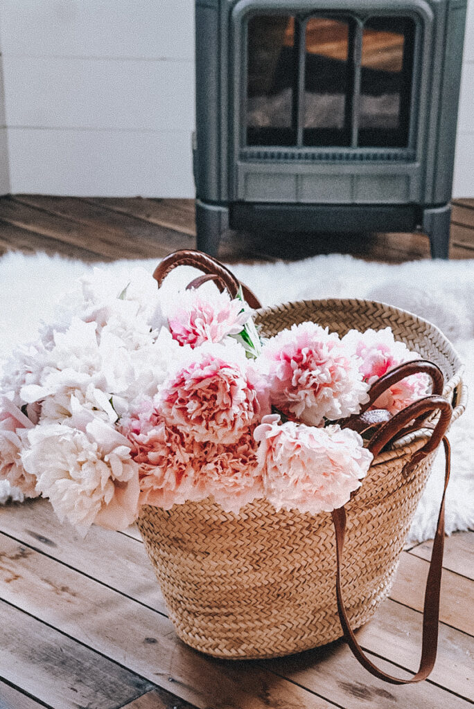 Large French market basket full of pink peonies.