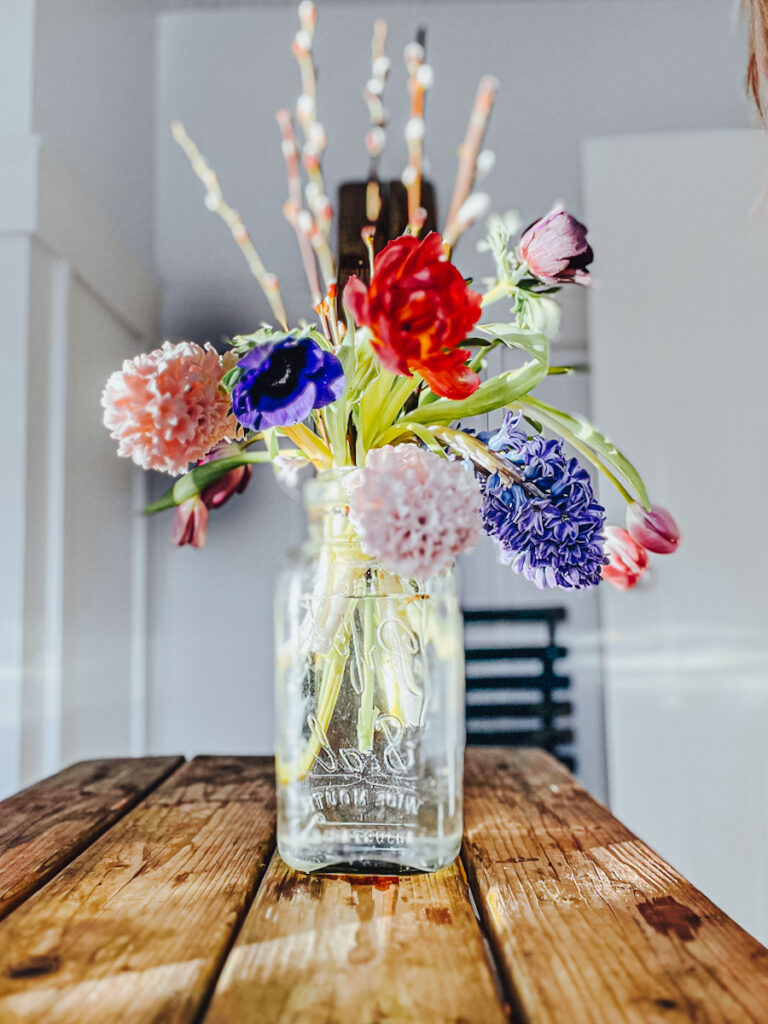 A beautiful spring arrangement with tulips, anemones and pussy willow.